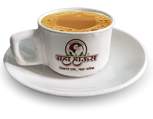 A white ceramic cup and saucer featuring the 'Chaha House' logo, filled with hot, frothy Indian masala chai.