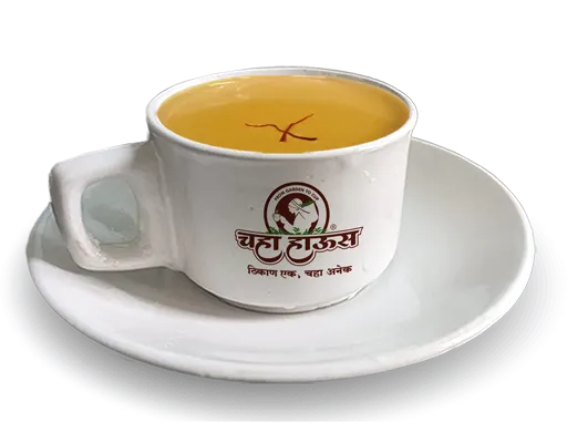Chaha Haus Kashmiri Kahwa tea served in a white cup with saffron garnish.