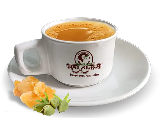 Hot masala chai served in Chalte Chalte branded tea cup with cardamom and jaggery.